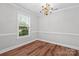 Bright dining room featuring hardwood floors, crown molding, and a classic chandelier at 2082 Egret Ct, Rock Hill, SC 29732