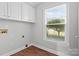 Bright laundry room with window, cabinets, and hookups at 2082 Egret Ct, Rock Hill, SC 29732