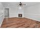 Spacious living room featuring wood floors, a fireplace, and natural light at 2082 Egret Ct, Rock Hill, SC 29732