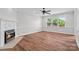 Cozy living room with wood floors, a ceiling fan, and a fireplace at 2082 Egret Ct, Rock Hill, SC 29732