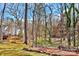 A sloped yard, framed by mature trees, offers a peaceful and private outdoor setting at 2406 Brook Canyon Dr, Charlotte, NC 28212