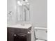 Bathroom featuring a dark vanity, sink, toilet, and a mirror at 2406 Brook Canyon Dr, Charlotte, NC 28212