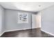 Bedroom with gray walls, dark laminate flooring, and a window with natural light at 2406 Brook Canyon Dr, Charlotte, NC 28212