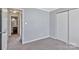 Bedroom featuring gray walls and carpet, a closet and access to the bathroom at 2406 Brook Canyon Dr, Charlotte, NC 28212