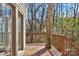 A wooden deck with a railing offers views of the surrounding wooded area at 2406 Brook Canyon Dr, Charlotte, NC 28212