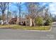 A home in a residential neighborhood features natural light, landscaping, and a well-manicured lawn at 2406 Brook Canyon Dr, Charlotte, NC 28212