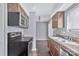 Updated kitchen featuring stainless steel appliances, wood cabinets, laminate countertops, and hardwood floors at 2406 Brook Canyon Dr, Charlotte, NC 28212