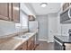 Kitchen featuring stainless steel appliances, wood cabinets, laminate countertops, and hardwood floors at 2406 Brook Canyon Dr, Charlotte, NC 28212