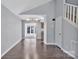 Open floor plan featuring hardwood floors, light gray walls, and open access to the kitchen and sunroom at 2406 Brook Canyon Dr, Charlotte, NC 28212