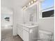 Bright bathroom featuring double vanity, tile floor, and a view to the main living space at 247 Batten Ridge Dr # 294, Statesville, NC 28677