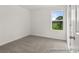 Bedroom with soft carpet, a window looking out to a pastoral view, and white walls at 247 Batten Ridge Dr # 294, Statesville, NC 28677