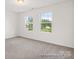 Bedroom features carpeted floors, neutral walls, and two large windows offering plenty of light at 247 Batten Ridge Dr # 294, Statesville, NC 28677