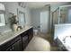 Spacious primary bath featuring double sinks, dark cabinetry, a walk-in shower and a soaking tub at 2640 Southern Trace Dr, Waxhaw, NC 28173