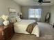 Relaxing bedroom featuring a large bed, soft carpet, neutral tones, and lots of natural light at 2640 Southern Trace Dr, Waxhaw, NC 28173