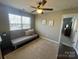 Bonus room with a futon, carpet, and natural light from the many surrounding windows at 2640 Southern Trace Dr, Waxhaw, NC 28173