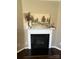 Close up of a decorative fireplace with a painting on the mantle at 2640 Southern Trace Dr, Waxhaw, NC 28173