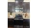 Dark cabinets and stainless steel appliances in a kitchen with granite countertops at 2640 Southern Trace Dr, Waxhaw, NC 28173