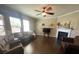 Spacious living room with a ceiling fan, many windows, and a decorative fireplace at 2640 Southern Trace Dr, Waxhaw, NC 28173