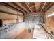 Unfinished basement with exposed ceiling and cinder block walls ready for customization and ample storage at 2915 Spencer Ne Rd, Conover, NC 28613