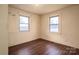 Bedroom with laminate floors and two windows at 2915 Spencer Ne Rd, Conover, NC 28613