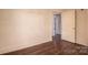 Unfurnished bedroom with wood floors and a white door at 2915 Spencer Ne Rd, Conover, NC 28613