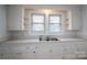 Functional kitchen featuring white cabinets, a double-basin sink, and practical countertops at 2915 Spencer Ne Rd, Conover, NC 28613