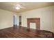 Bright living room features a brick fireplace, ceiling fan and hardwood floors at 2915 Spencer Ne Rd, Conover, NC 28613