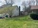 View of the spacious backyard featuring lush green grass and mature trees at 3301 Green Meadow Dr, Charlotte, NC 28269