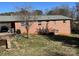 Rear view of a brick home with a lawn and mature trees shading the backyard at 356 Lucky Hollow Rd, Hickory, NC 28601