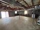 Large unfinished basement features a washer, dryer, workbench, and exterior access at 356 Lucky Hollow Rd, Hickory, NC 28601