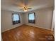 Neutral bedroom with hardwood floors, two windows, and ceiling fan at 356 Lucky Hollow Rd, Hickory, NC 28601