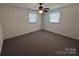 This carpeted bedroom features neutral walls, natural light, and a ceiling fan at 356 Lucky Hollow Rd, Hickory, NC 28601