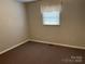 This carpeted bedroom features neutral walls, natural light, and a comfortable atmosphere at 356 Lucky Hollow Rd, Hickory, NC 28601