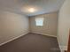 This carpeted bedroom features soft lighting, a textured ceiling and a cozy atmosphere at 356 Lucky Hollow Rd, Hickory, NC 28601