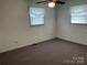 This carpeted bedroom features neutral walls, natural light, and a ceiling fan at 356 Lucky Hollow Rd, Hickory, NC 28601