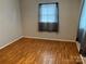 This cozy bedroom offers warm hardwood floors and a window with sheer curtains at 356 Lucky Hollow Rd, Hickory, NC 28601