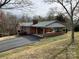 Charming single-story brick home with a covered carport and freshly paved driveway at 356 Lucky Hollow Rd, Hickory, NC 28601