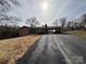 Brick home on a hill features an attached carport and beautiful mature trees at 356 Lucky Hollow Rd, Hickory, NC 28601