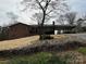 Brick home exterior featuring attached carport, manicured lawn, and mature landscaping at 356 Lucky Hollow Rd, Hickory, NC 28601