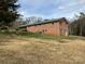 View of brick house with covered patio and driveway, ample land and mature trees at 356 Lucky Hollow Rd, Hickory, NC 28601