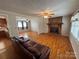 Inviting living room featuring a brick fireplace, hardwood floors and neutral walls at 356 Lucky Hollow Rd, Hickory, NC 28601