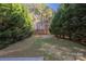 Private backyard with mature trees and a concrete patio at 4528 Potters Glen Rd, Charlotte, NC 28269