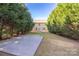 Expansive backyard with mature trees and concrete patio at 4528 Potters Glen Rd, Charlotte, NC 28269