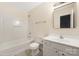 A bright bathroom with a shower-tub combo, white vanity, and a large mirror above the sink at 4528 Potters Glen Rd, Charlotte, NC 28269