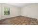 Bright bedroom with a window letting in natural light and beautiful wood plank flooring at 4528 Potters Glen Rd, Charlotte, NC 28269