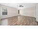 Spacious bedroom with two windows, ceiling fan, and stylish wood plank flooring at 4528 Potters Glen Rd, Charlotte, NC 28269