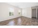 A bedroom features wood-look floors and bright, natural light from two large windows at 4528 Potters Glen Rd, Charlotte, NC 28269