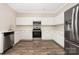 A kitchen features stainless steel appliances, white cabinets, and wood-look floors at 4528 Potters Glen Rd, Charlotte, NC 28269