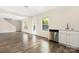 Open-concept living room with wood floors, natural light, and modern kitchen area at 4528 Potters Glen Rd, Charlotte, NC 28269