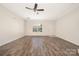 Living room featuring a ceiling fan, hardwood floors, and natural light at 4528 Potters Glen Rd, Charlotte, NC 28269